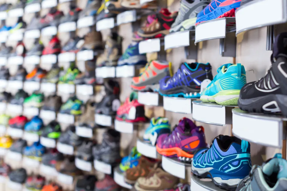 Wall of colorful sneakers for sale at a shoe store.